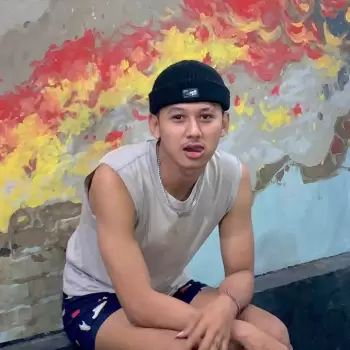 pria, muda, santai, kasual, berpose, topi beanie, tanpa lengan, kaos, celana pendek, duduk, dinding, seni dinding, warna-warni, abstrak, pemuda, gaya, keren, percaya diri, candid, potret, indoor, siang hari, senyum, ekspresi wajah, orang, laki-laki, remaja, bebas, urban, artistik.